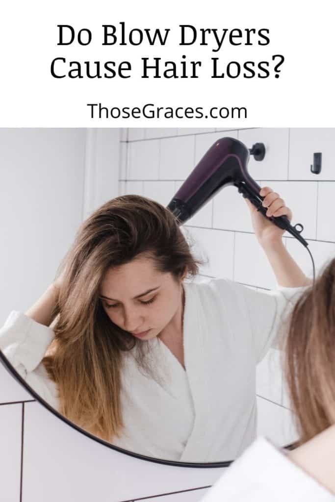 lady drying her hair using a blow dryer in the bathroom