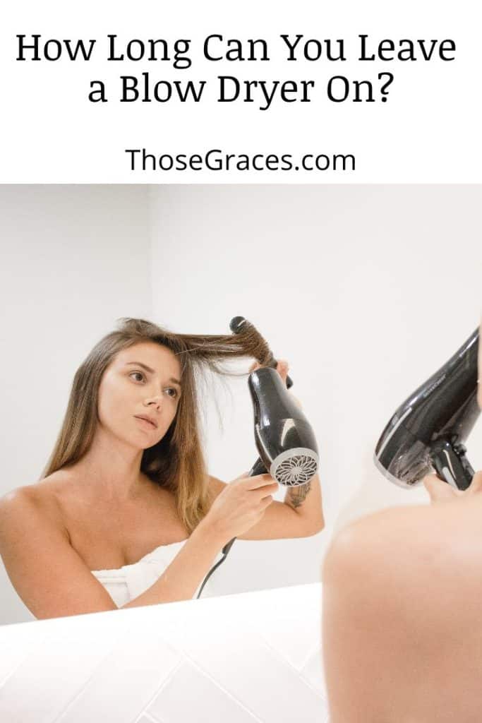 lady drying her hair in front of the mirror