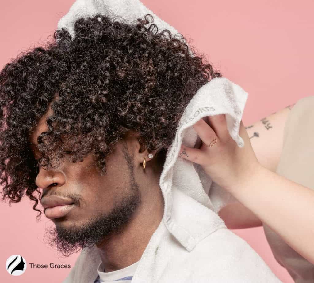 drying men's curly hair using a towel