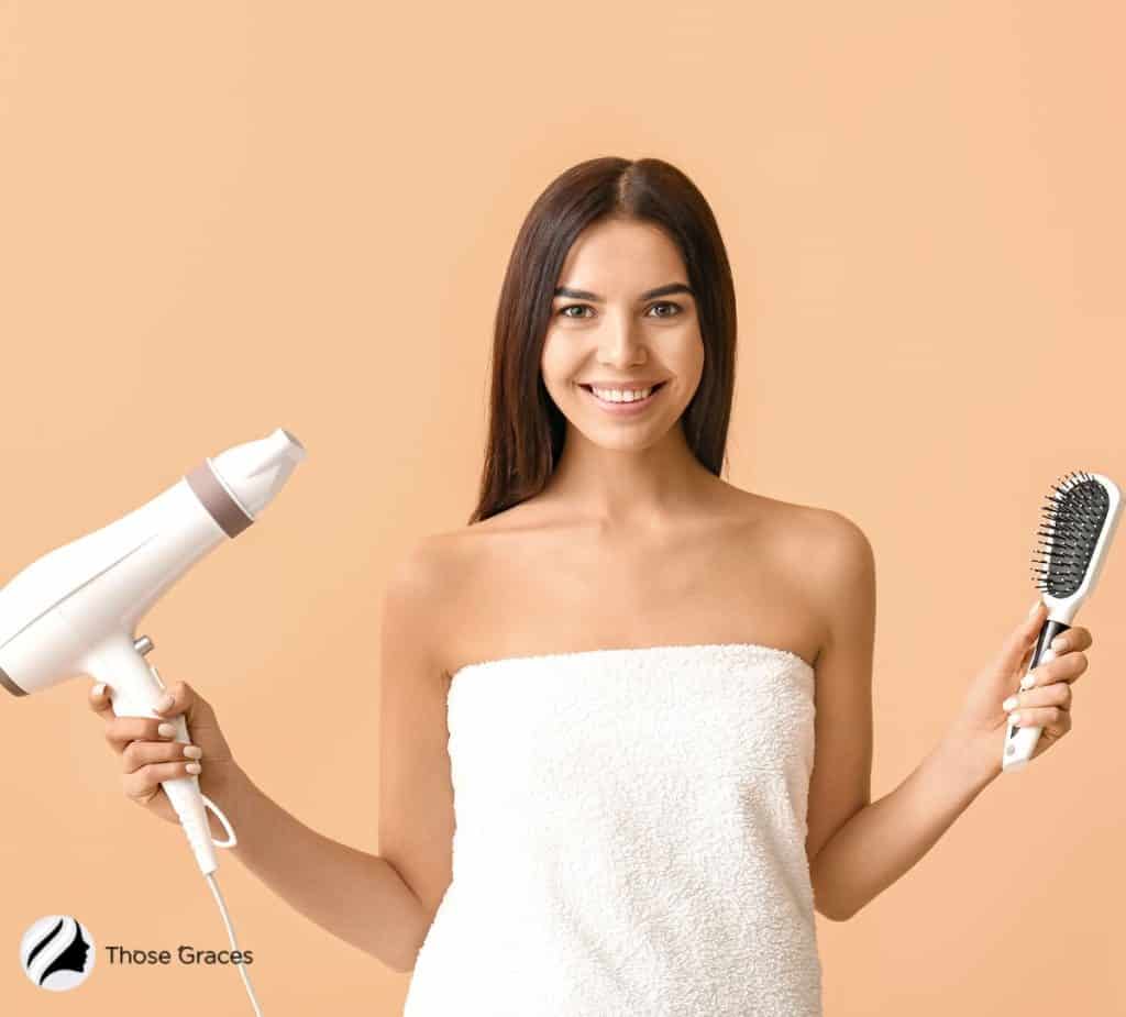 lady holding a brush and hair dryer