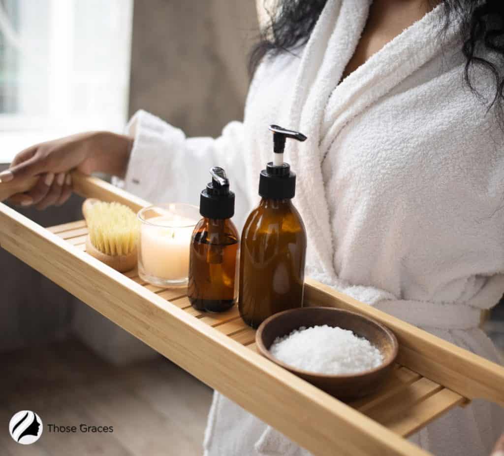 LADY CARRYING ESSENTIAL OIL AND OTHER SPA ESSENTIALS