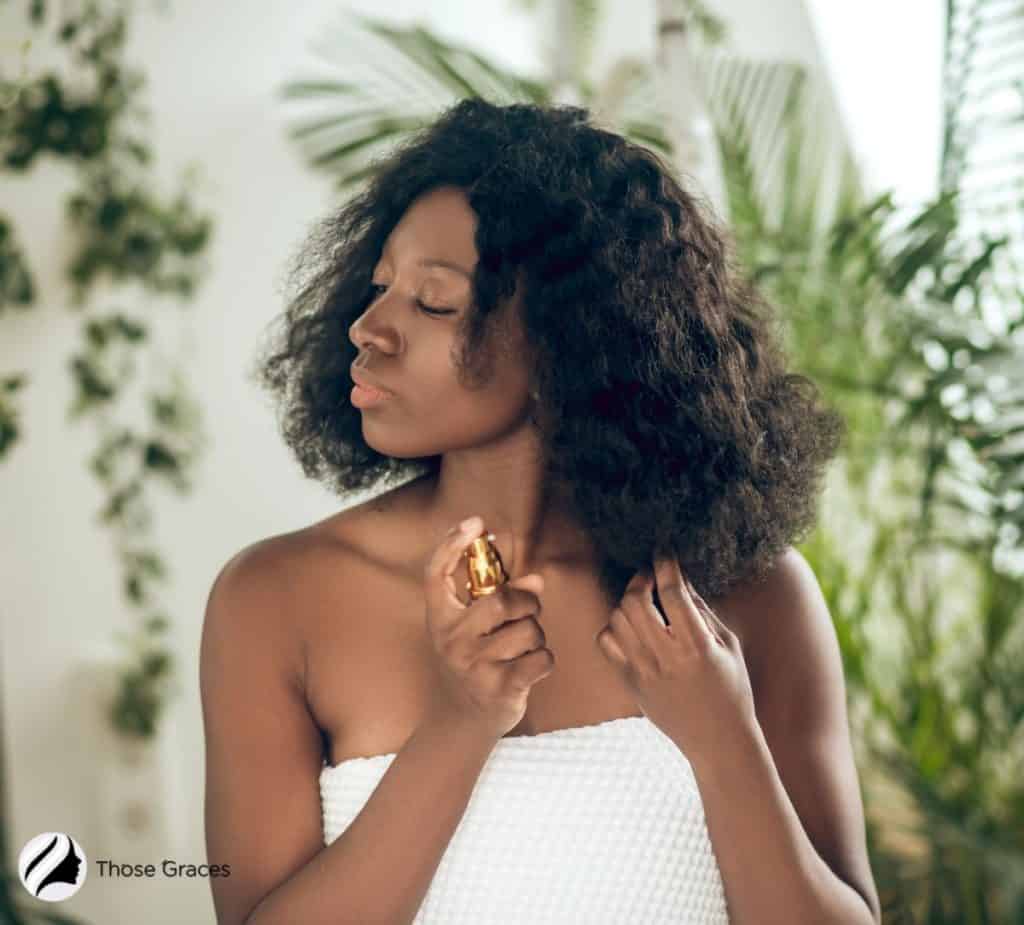 lady spraying her hair with heat protectant