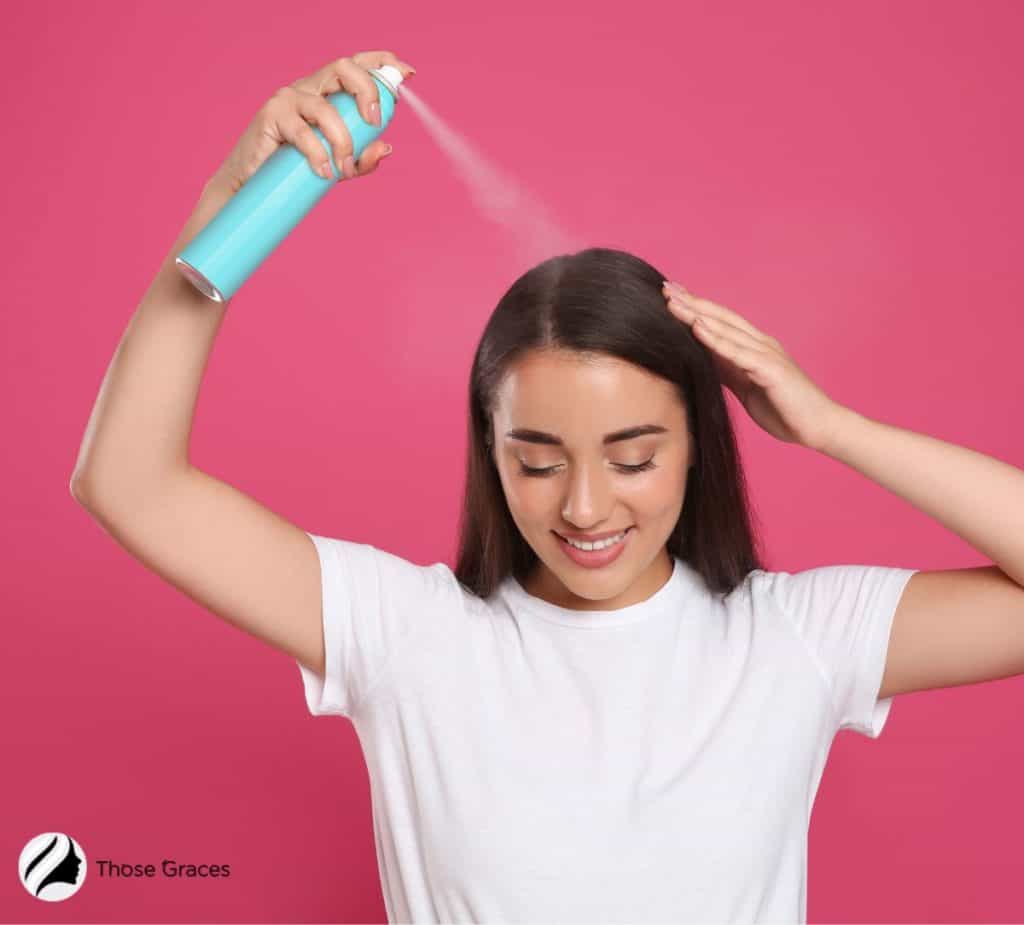 lady spraying her hair 