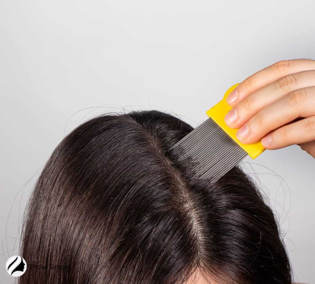 lady using a lice comb