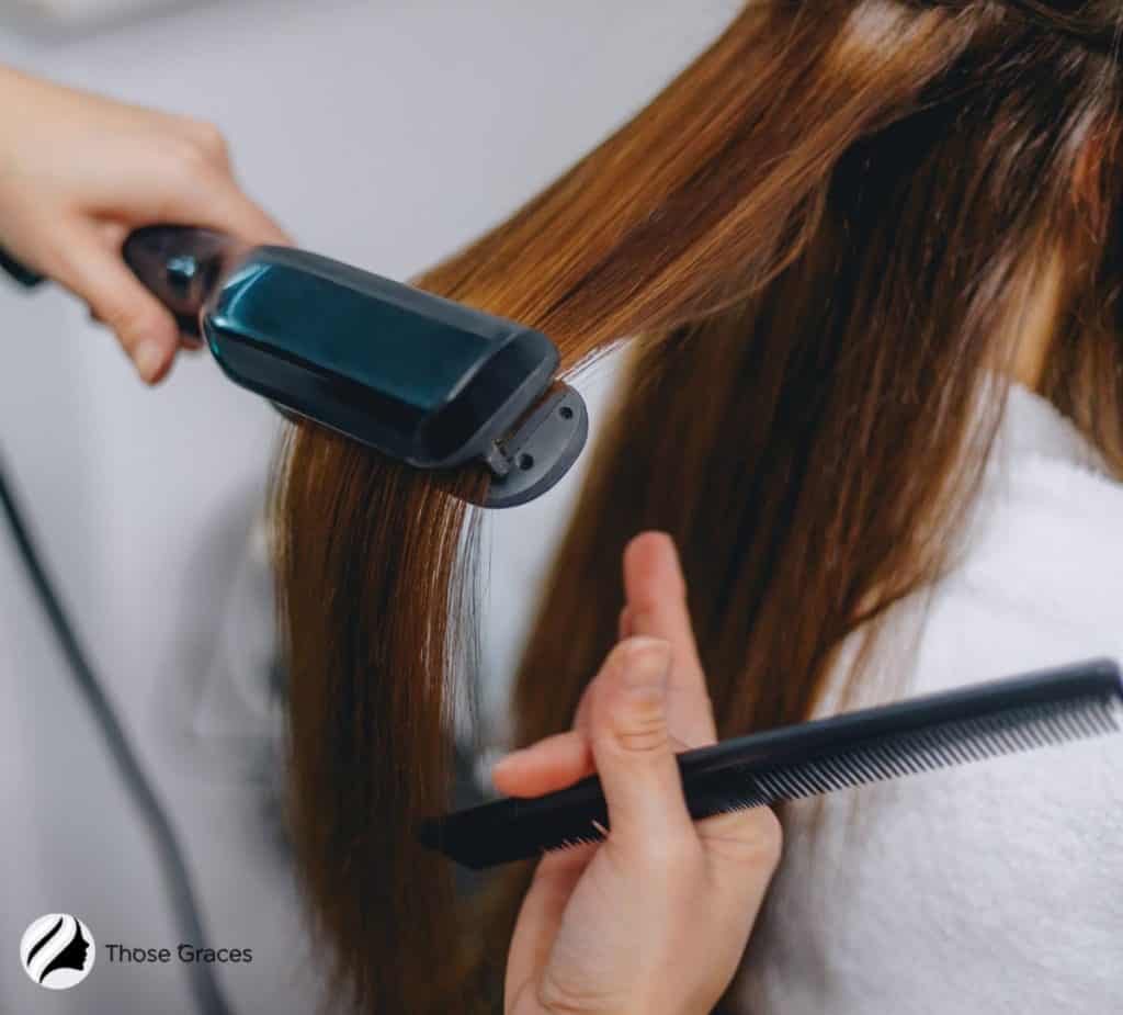 straightening hair using a flat iron