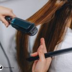 straightening hair using a flat iron