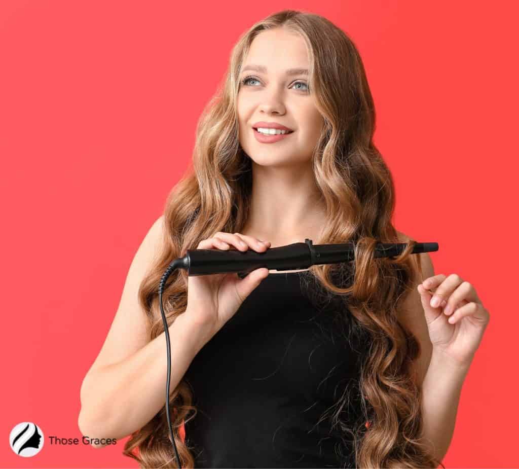 woman curling her hair using a curling iron