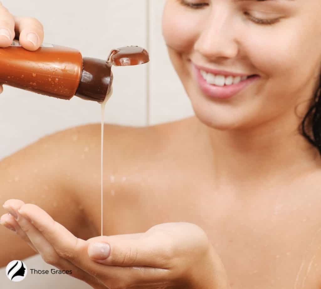 woman pouring shampoo on the hand of a woman